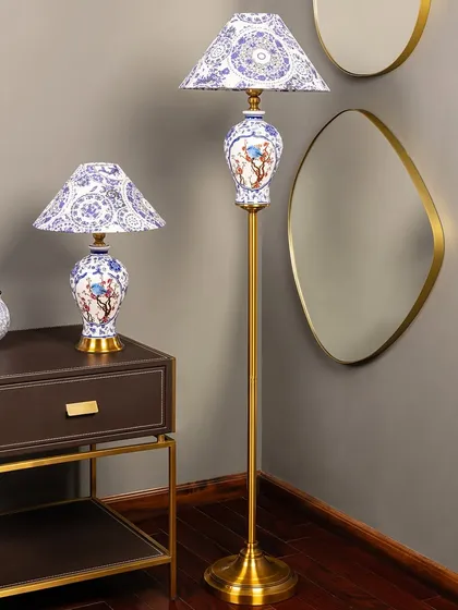This blue and white ceramic lamp set features a timeless bird and floral motif. The matching table and floor lamps create a harmonious look, bringing classic blue pottery elegance to your space.