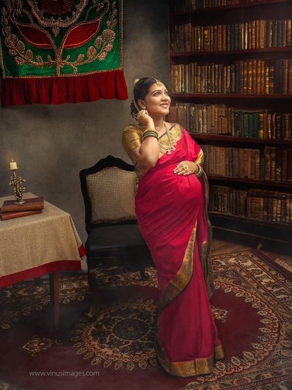 A thoughtful pose in a vintage library setting. The mother-to-be looks up, as if dreaming of the future, surrounded by the timeless knowledge of the past.