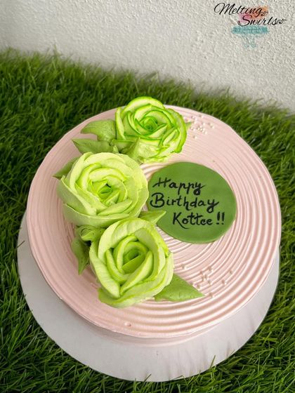 Another example of our floral piping, this time with vibrant green whipped cream roses on a pink cake.