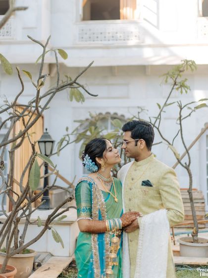 A romantic portrait of the couple in a beautiful courtyard, their traditional outfits complementing the classic architecture.