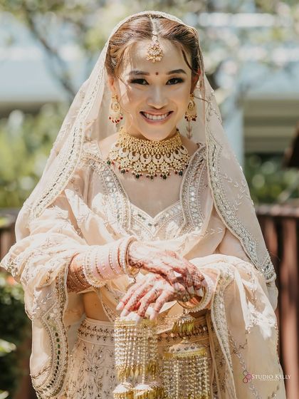 A beautiful portrait of the bride, showcasing her radiant smile and traditional Kalire jewelry.