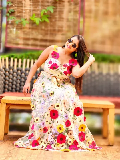 A relaxed moment during a fantastic Haldi function. The floral dress and sunny vibe are perfect for a daytime celebration filled with fun and laughter.