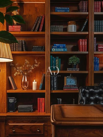 A detail of "The British Study," showcasing the floor-to-ceiling bookshelf filled with classic volumes. The warm light from the table lamp creates a cozy and inviting atmosphere, perfect for losing oneself in a good book.