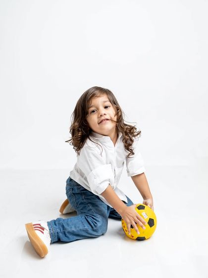 A solo shot of the little boy with his ball, capturing his personality during the family session.