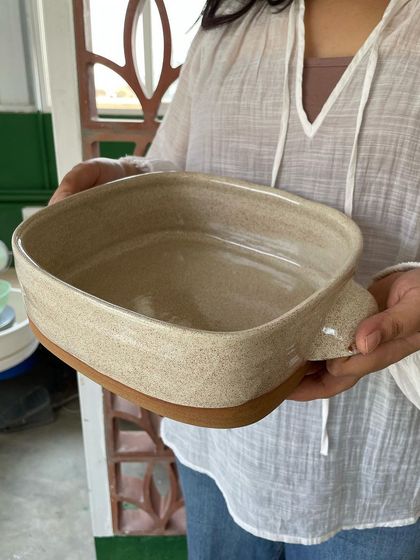 Another view of the baking dish, highlighting the speckled clay body.