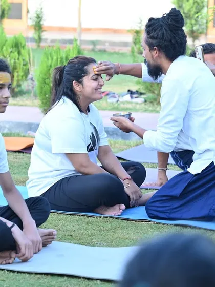 A sacred moment of applying a tilak during our yoga celebration. We honor the traditions and the spiritual essence of yoga.