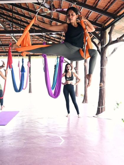 A powerful and graceful pose in the aerial hammock. This student is beautifully demonstrating the strength and artistry that can be found in aerial yoga.