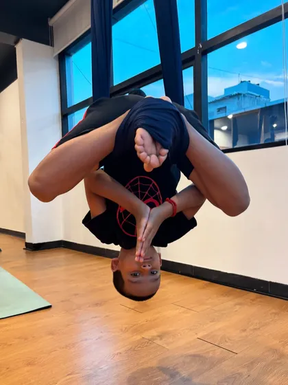 The pure joy of aerial yoga. This young yogi masters an inverted pose in the hammock, building incredible core strength and confidence while experiencing the fun of flying.