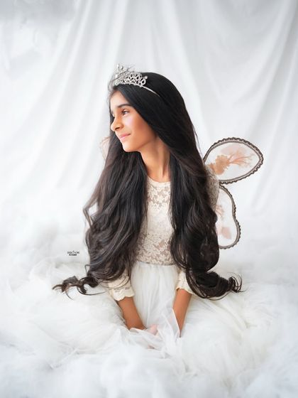 A serene and graceful portrait of an older sister dressed as a beautiful fairy.