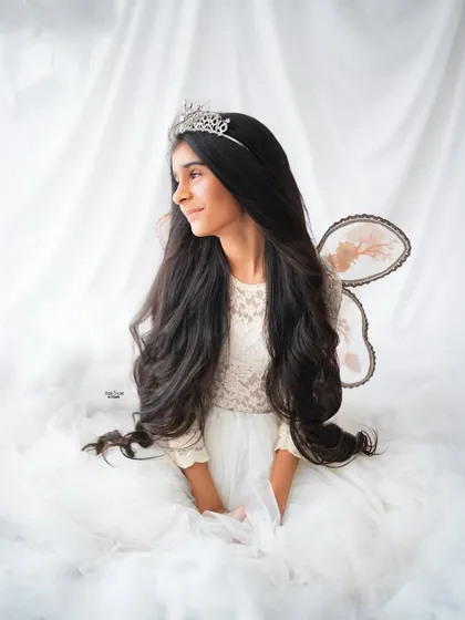 A serene and graceful portrait of an older sister dressed as a beautiful fairy.