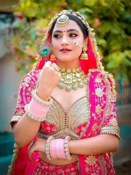 A thoughtful pose from an outdoor bridal shoot, capturing the details of the matha patti and necklace.