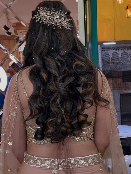 A detailed shot of the beautiful crystal hair accessory and the perfectly formed curls.
