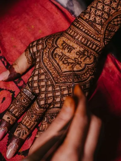 Adding personal touches is what makes henna so special. For this bride, we included the phrase 'Papa ki Laadli' (Daddy's Darling) right in the heart of the design, a sweet tribute to her father on her wedding day.