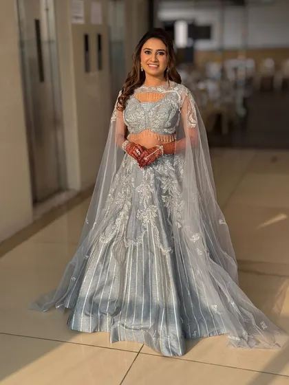 A full-length shot showing the beautiful silhouette of the sangeet outfit. The hair and makeup complete this modern, elegant look.