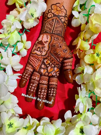Another beautiful Karwachauth mehendi design, surrounded by flowers.