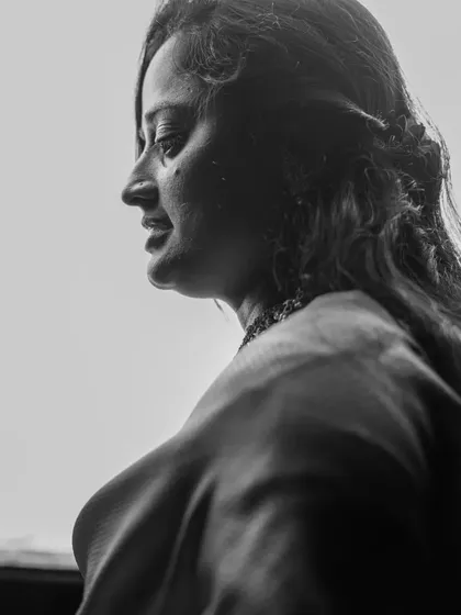 A thoughtful and artistic black and white profile shot, creating a timeless and contemplative mood.