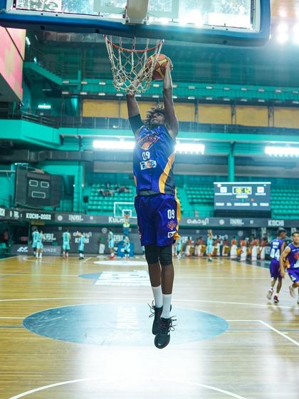 A powerful dunk captured at an INBL game. We ensure our event lighting and setup are perfect for capturing these dynamic, high-impact sports photography moments.