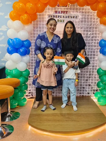 Children proudly hold the Indian flag while posing for a photo. We provide props and a festive environment to make the celebration memorable for our little patriots.