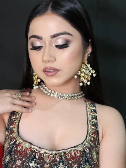 A soft and elegant pose showcasing the shimmering lid and flawless blending of the cut-crease eyeshadow.