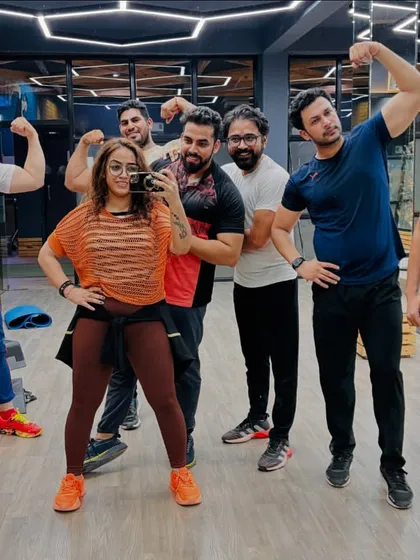 The morning Zumba gang, full of energy and ready to crush it. A mirror selfie capturing the smiles and muscles after a great cardio session. This is how we start our day.