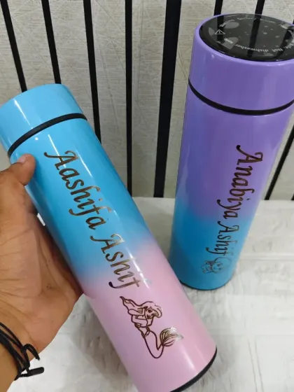 I offer bottles in beautiful gradient colors too. This image shows two temperature-display bottles in mermaid-themed pastels, each engraved with a name.