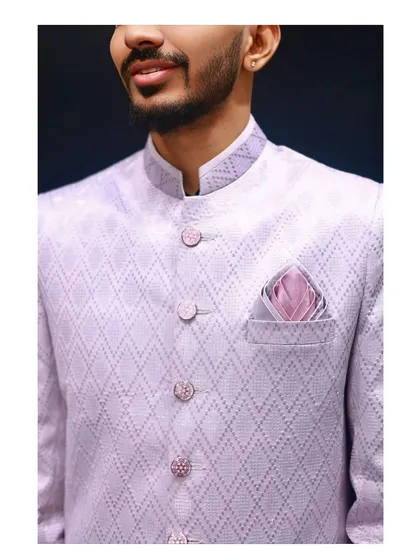 A close-up shot of the lavender Indo-western, focusing on the collar, buttons, and pocket square detail. This highlights the fine texture of the fabric and the perfect tailoring around the chest and shoulders.