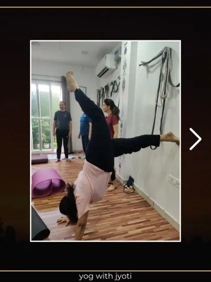 Another student practicing a twisted handstand, showing progress and dedication to mastering advanced poses.