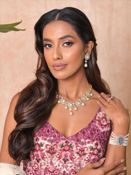 Another angle of this beautiful festive look. The soft, warm tones of the makeup enhance the model's natural skin tone, creating a harmonious and elegant aesthetic.