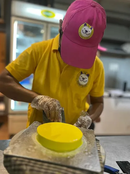 Our baker carefully frosts a bright yellow Easter cake. We use natural color from turmeric to achieve this sunny hue.