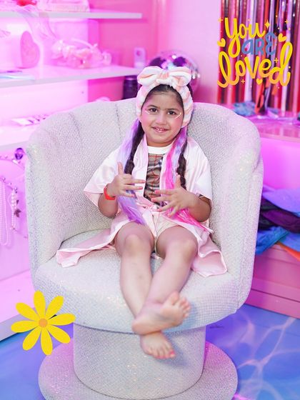 A picture of pure happiness. This little girl, with her hair done up and a big smile, embodies the fun and confidence our 'Divas of Wooray' experience is all about.