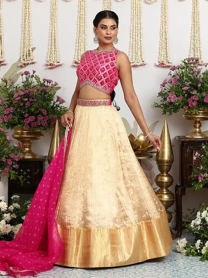 The full view of our gold and pink lehenga set, showcasing the beautiful flare of the silk skirt and the vibrant pop of color from the blouse and dupatta. A perfect blend of tradition and modernity.