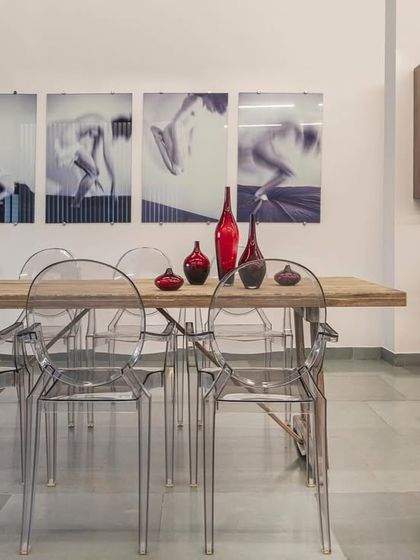 Another angle of the industrial-meets-elegance showroom. The space is a dance of contrasts, with raw materials playing against refined art and furniture.