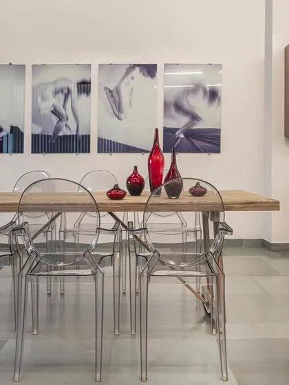 Another angle of the industrial-meets-elegance showroom. The space is a dance of contrasts, with raw materials playing against refined art and furniture.