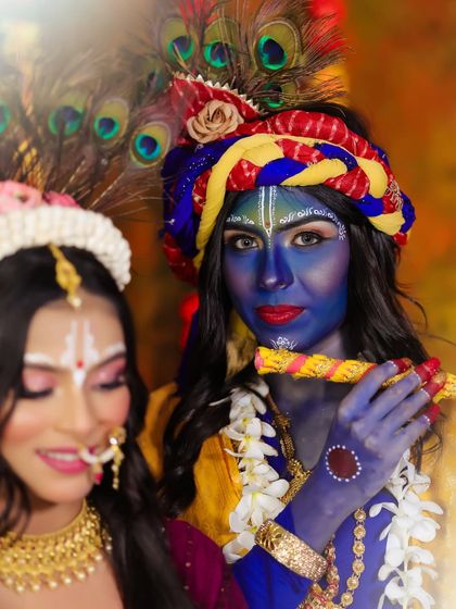 A portrait of Krishna, with Radha in the background, creating a sense of depth and story.