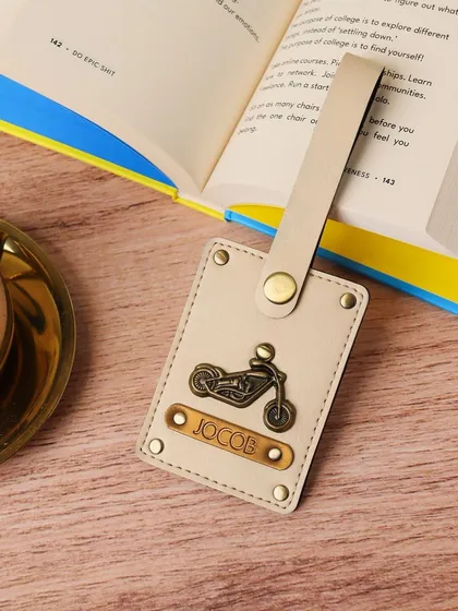 This personalized luggage tag for 'Jacob' features a motorcycle charm, making it a perfect accessory for a biker to easily identify their bags.