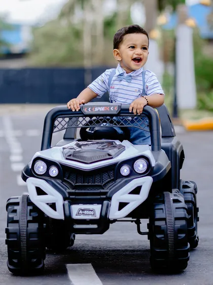 Having a blast in a mini toy truck! I use fun props like this to let kids play and capture their genuine excitement during the photoshoot.