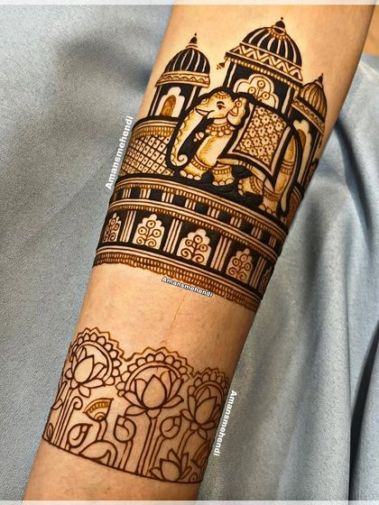 The bridal arm design in progress. This view shows the main elephant and palace band, with the lotus border below it just beginning to be outlined.