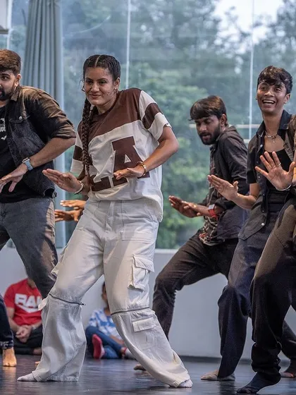 A close-up of the group in action, showing the fun and energy of the choreography.