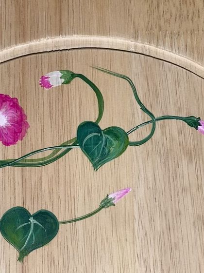 A close-up detail of a morning glory vine, showing the heart-shaped leaves and delicate tendrils.