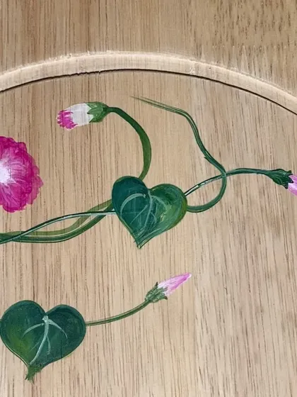 A close-up detail of a morning glory vine, showing the heart-shaped leaves and delicate tendrils.