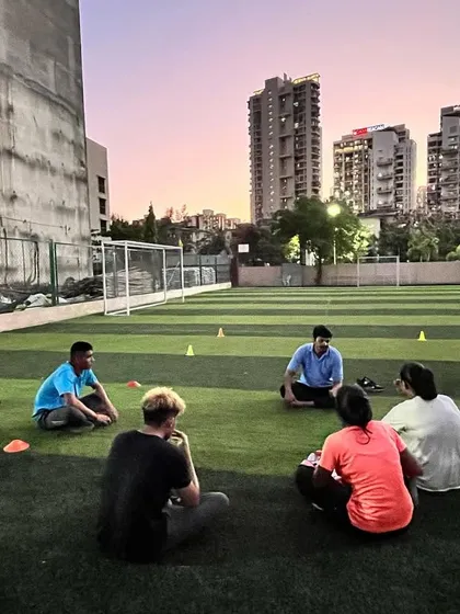 As the sun sets, we cool down and reflect. These group discussions are vital for building a strong team bond and ensuring every boxer understands the 'why' behind their training.