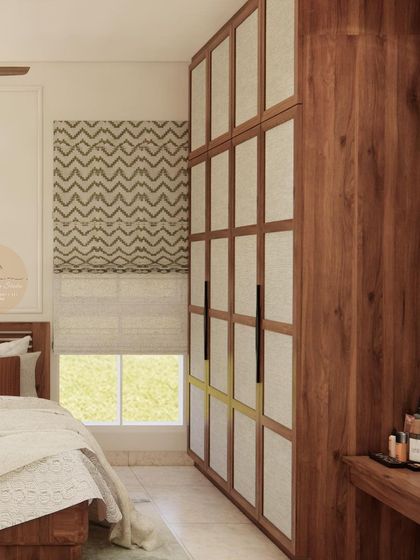 A guest bedroom design with a mint green accent wall and a wardrobe with wood and fabric paneling.