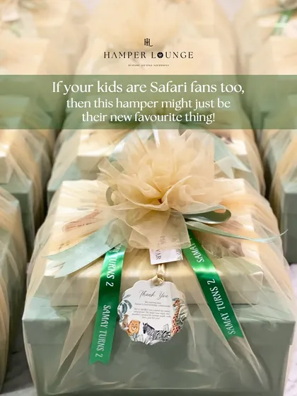 For a safari-themed second birthday, I created these elegant return gifts. Each box contains a leather organizer and custom stationery, beautifully wrapped in net with a personalized ribbon.