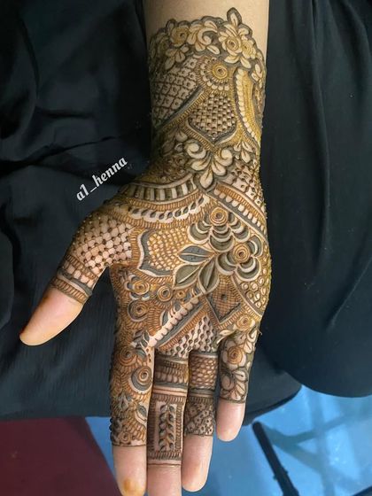 A single hand with a detailed Pakistani-style design, perfect for a wedding guest.