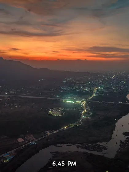 The city lights of Badlapur start to come on at 6:45 PM, creating a magical twilight view.