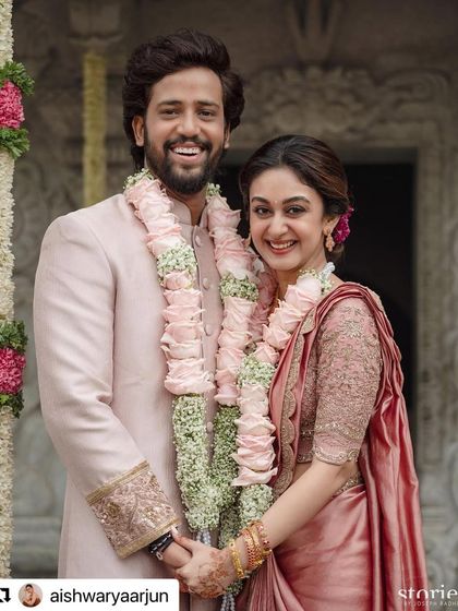Congratulations to this beautiful couple on their engagement. We created a soft, romantic glam for the bride, featuring a messy floral bun and makeup in rosy tones to complement her saree.