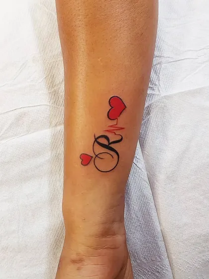 An initial 'R' combined with a heartbeat line and red hearts. A personalized design that is full of life and love.