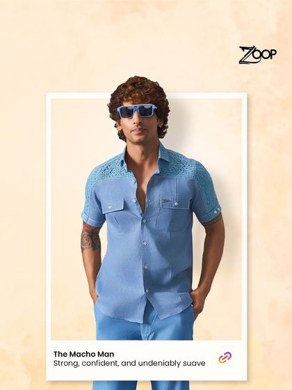 Bold, powerful, and undeniably suave. This blue half-sleeve shirt with textured shoulder details is designed for the modern, confident man.