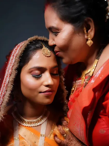 A touching moment between the bride and her mother, a memory to cherish forever. The bride's makeup is soft and emotional.