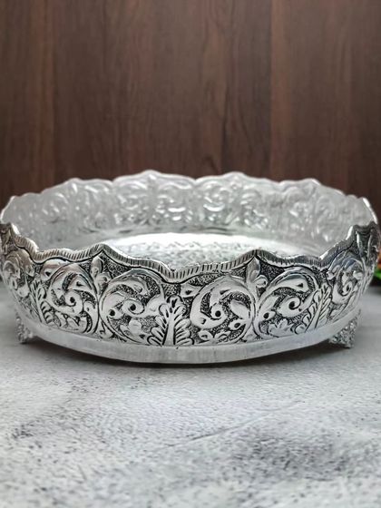An antique German silver urli with a flower design. Urlis are traditionally used to float flowers and candles, creating a serene atmosphere.